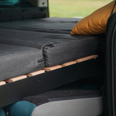 Product shot of camping mattress and slatted frame in the car.