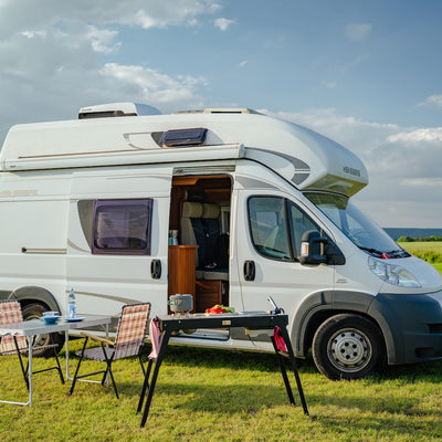 Camping kitchen in front of motorhome.